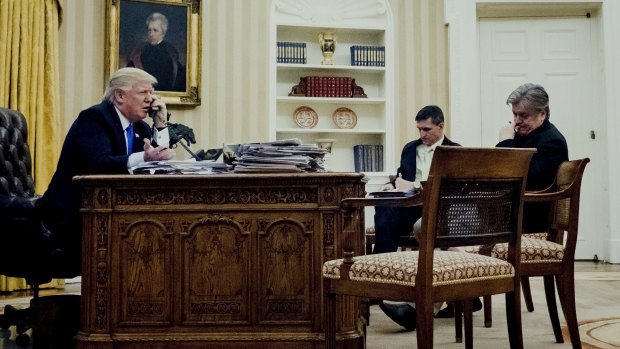 Donald Trump, left, on the phone with Australian PM Malcolm Turnbull, as Michael Flynn, US national security advisor, centre, and Steve Bannon, wait.