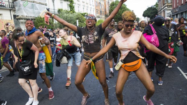Revellers dance at the Notting Hill Carnival in London, England. 