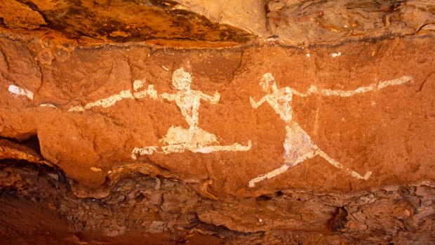 Running figures painted onto the walls of Uan Muhuggiag, one of Wadi Teshuinat's caves.