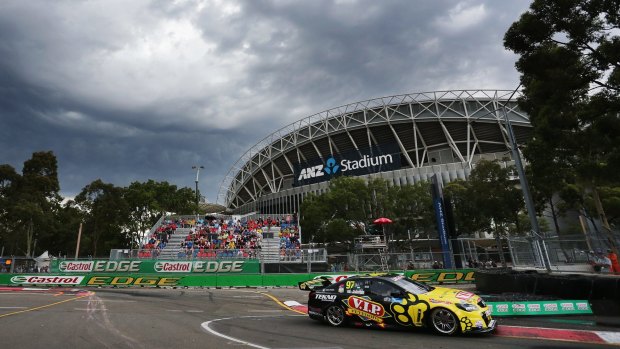 Storm clouds roll in as Shane van Gisbergen navigates his way around the Sydney Olympic Park street circuit..