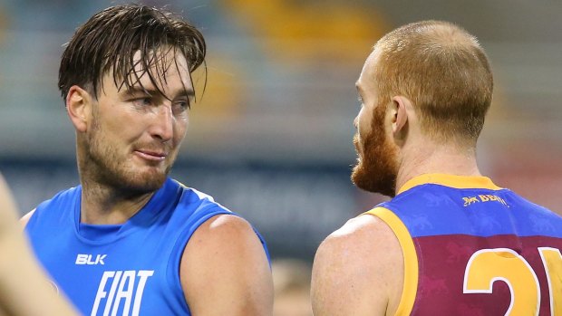 Charlie Dixon of the Suns and Daniel Merrett of the Lions exchange words in round 19.