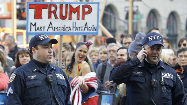 Police officers patrol an anti-Trump protest outside a Pennsylvania hotel where Donald Trump was attending a luncheon on Friday.