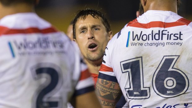 Tense moments: Mitchell Pearce directs his team as the match goes to the wire.