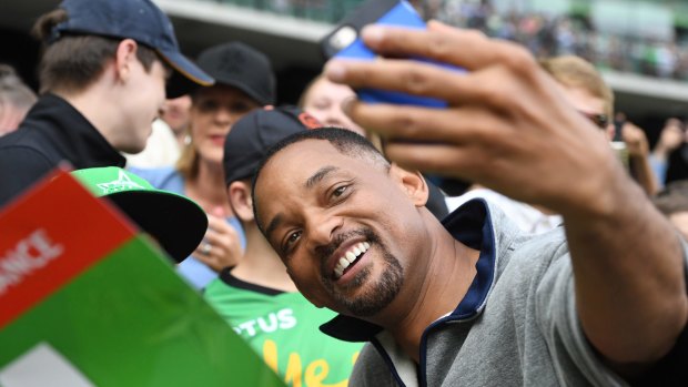 Thunder-struck: Hollywood actor Will Smith poses for selfies at the MCG.