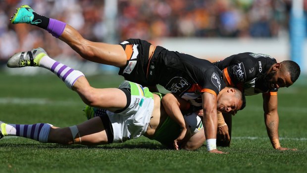 On the receiving end this time: Jack Wighton is tackled during the round 26 NRL match between the Wests Tigers and the Canberra Raiders at Leichhardt Oval.