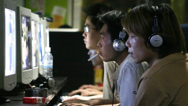 Chinese hackers can be both from the government and freelance. Pictured: Chinese youths surf the net at a cyber cafe in Shanghai, China.