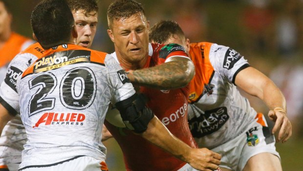 Full contact: Tariq Sims charges into the Tigers defence.