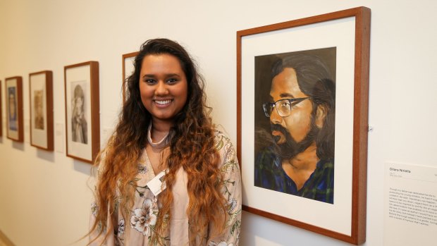 Young Archibald Prize winner of the 16-18 years category, Dilara Niriella, with her portrait of her father.