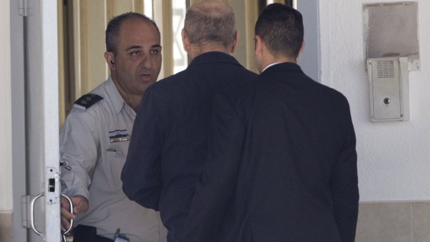 Former Israeli prime minister Ehud Olmert enters prison to begin his sentence in the central Israeli town of Ramle, Israel, on Monday.