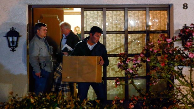 German police carry boxes out of a house believed to belong to the parents of Germanwings co-pilot Andreas Lubitz on Thursday.