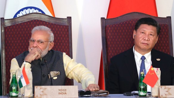 Indian Prime Minister Narendra Modi, left, and Chinese President Xi Jinping listen to a speech during the BRICS Leaders Meeting in Goa, India, last year.