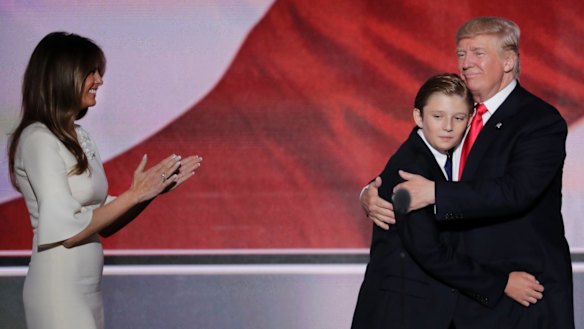 Donald Trump hugs his son Barron as wife Melania watches during the final day of the Republican National Convention in July.