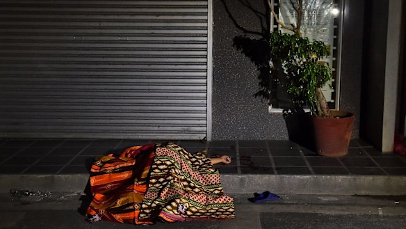 One of two people killed in a double shooting in the Manila suburb of Baclaran, lies in the street. 