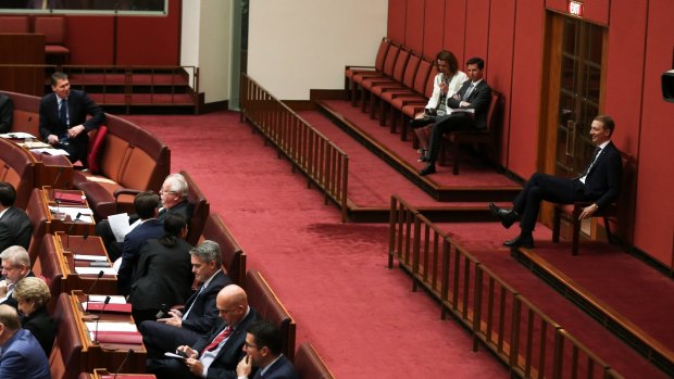 Senator Cory Bernardi looks over his should as senators Anne Ruston, Simon Birmingham and James Paterson abstain during a division in the Senate.