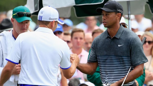 Friendly facade:  Sergio Garcia shakes hands with Tiger Woods on the first tee.