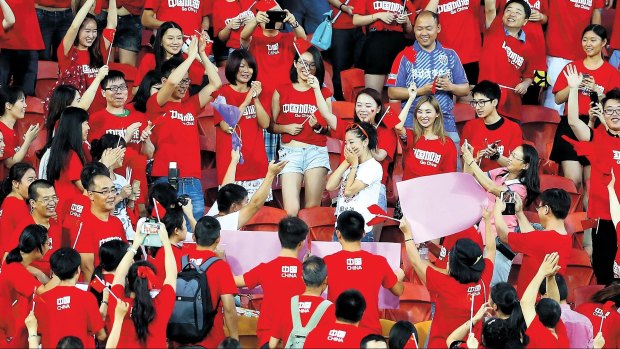 A Chinese fan proposes to his girlfriend before kick-off.