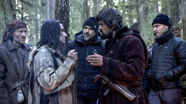 Director Alejandro González Inarritu (centre) looks on as a scene with Leonardo DiCaprio (second from right) is rehearsed.