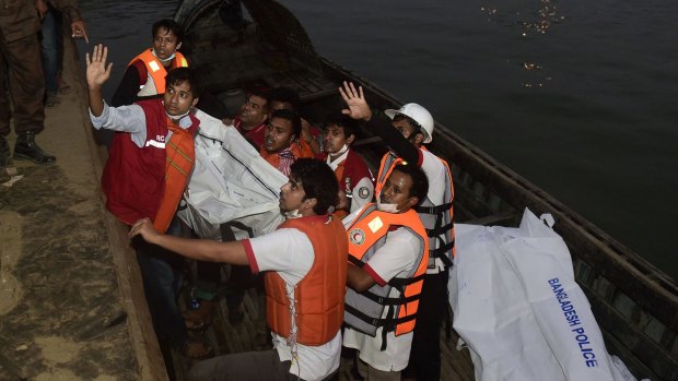Bangladeshi rescue workers recover the body of a victim after a ferry accident at Paturia, 70km east of Dhaka, on Sunday.