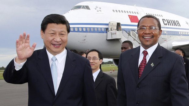 Chinese President Xi Jinping waves next to his Tanzanian counterpart Jakaya Kikwete, right, upon his arrival in Dar es Salaam, Tanzania in March 2013. 
