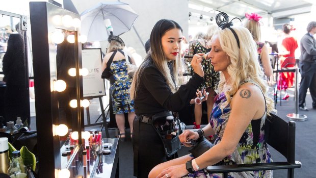 A racegoer has her make-up touched up at the Westfield Style Stakes at the Caulfield Guineas on Saturday.