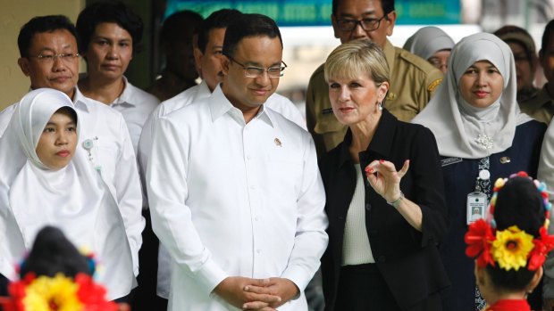 Anies Baswedan listens to Julie Bishop in the Jakarta suburb of Menteng in March 2016, when he was a minister in the Indonesian government.