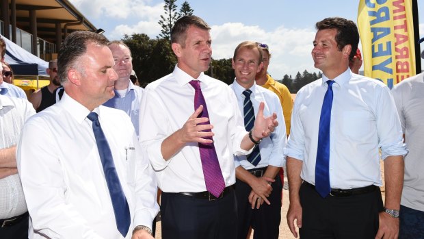 Premier Mike Baird, with Terrigal Liberal candidate Adam Crouch, left and The Entrance Liberal candidate Michael Sharpe, right, at Terrigal.  