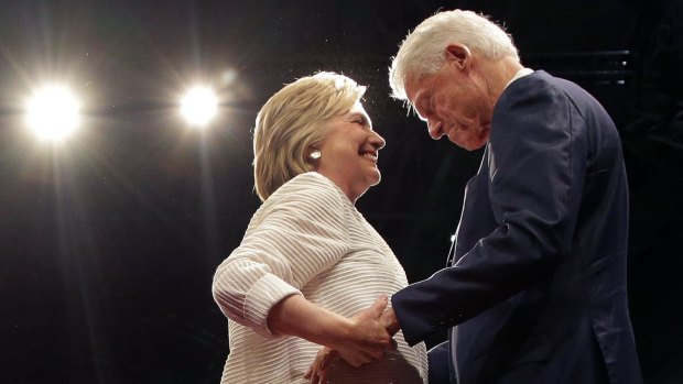Hillary Clinton greets her husband, former president Bill Clinton.