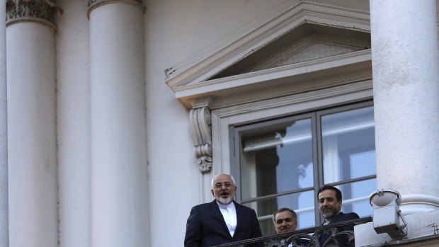Iranian Foreign Minister Mohammad Javad Zarif (left) talks to a journalist from a balcony of the Palais Coburg.