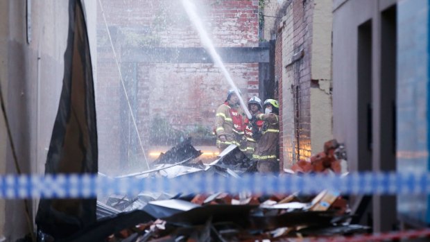 MFB fire crews work to put out the last of the flames at a fire inside a restaurant in Lygon street.