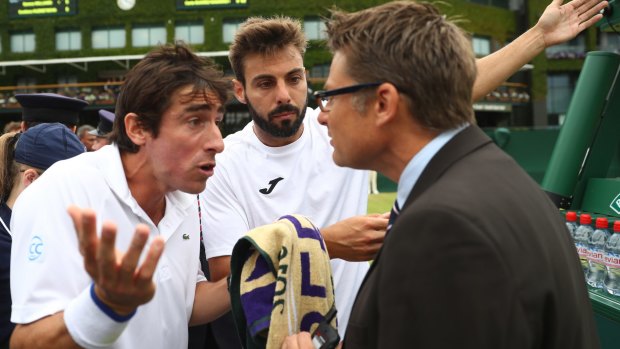 Dramatic scenes: Pablo Cuevas of Uruguay (L) and Marcel Granollers of Spain (R) argue with the match referee.