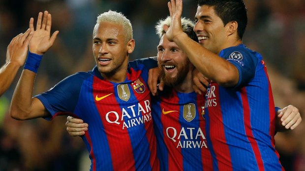 Deadly trio: Barcelona's Lionel Messi, centre, celebrates with  teammates Luis Suarez, right, and Neymar.