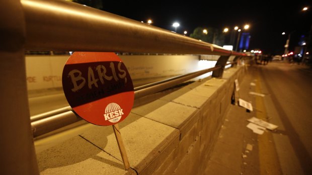 A placard that reads 'Peace' is left at the site of Saturday's attack.