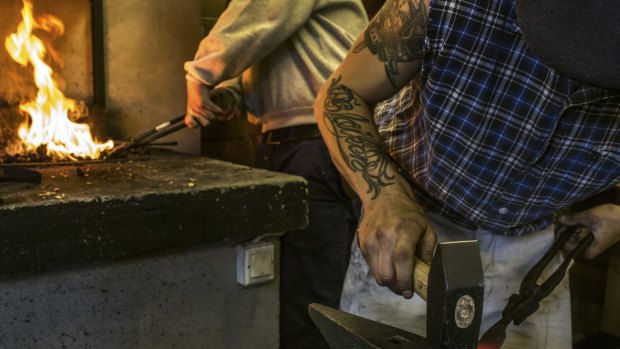 Students prepare metal parts during a class at Scandinavia's first government-funded training course on how to live like a Viking in Seljord, Norway.