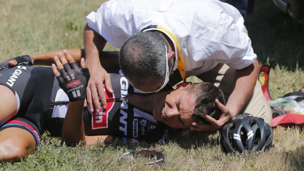 A medic tends to Barguil after he crashed during Wednesday's 10th stage.