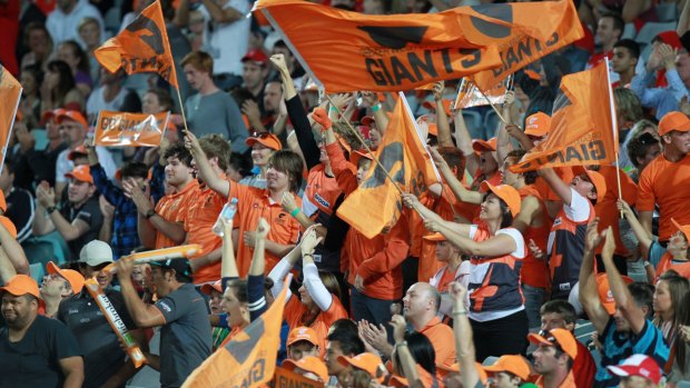Growing force: GWS Giants fans at ANZ Stadium, Sydney, react after the team scores a goal.