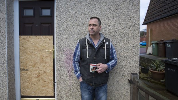 Former British soldier Rob Lawrie stands outside his house in Guiseley, England.