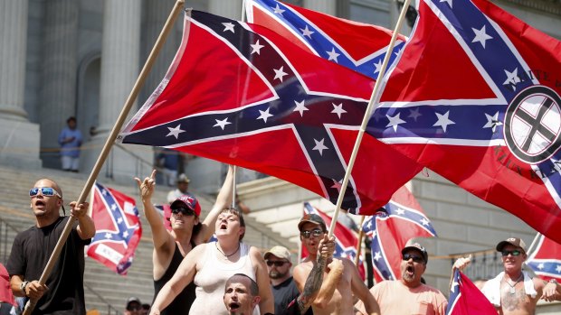 Members of the Ku Klux Klan fly Confederate flag at the statehouse in Columbia, South Carolina.