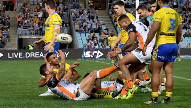Anything you can do: Malakai celebrates a try for Wests Tigers against Parramatta.