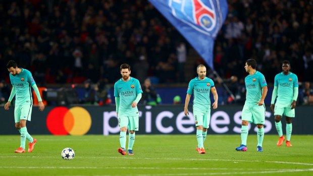 Beaten, and beaten well: Barcelona players feel the pain in Paris.