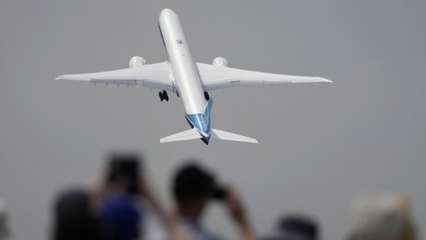A Boeing 777X plane takes off at the Farnborough Air Show on Monday during its demonstration flight.