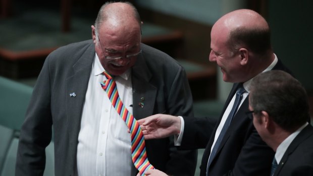 Liberal MP Trent Zimmerman looks at the rainbow tie of Warren Entsch during debate on the marriage bill on Monday.