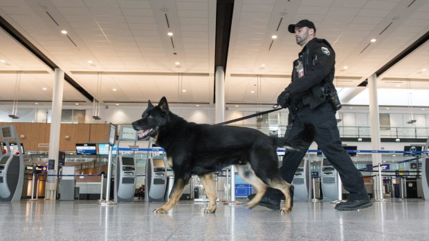 A police officer patrols the Pierre Elliott Trudeau International Airport in Montreal, Canada, on Tuesday after the Brussels attacks.