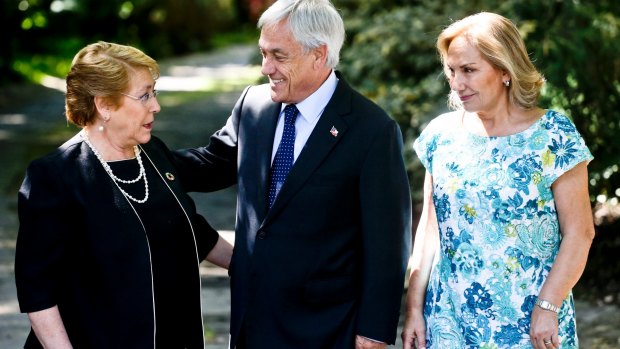Chilean President Michelle Bachelet, left, talks with president-elect Sebastian Pinera, a former president, as Pinera's wife Cecilia Morel looks on.