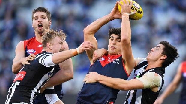 In-tight: Christian Petracca is tackled by Brayden Maynard.