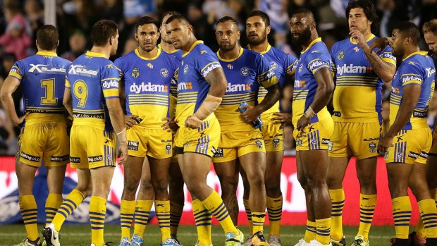 Somber mood: The Eels players await a video decision during their clash with the Sharks.