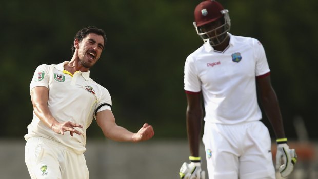 You beauty: Mitchell Starc celebrates bowling West Indies spinner Devendra Bishoo late on day three of the first Test at Windsor Park, Dominica.