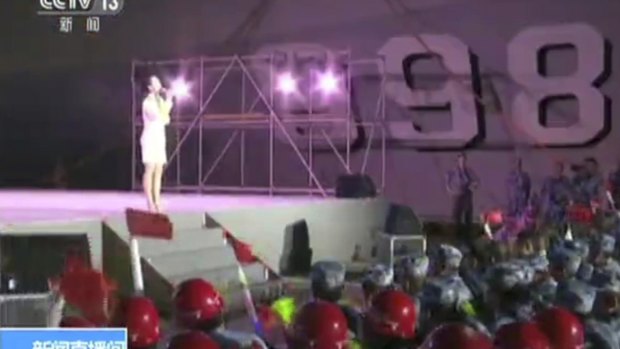 A singer performs for Chinese navy officers and construction workers on Fiery Cross Reef in the disputed South China Sea. 