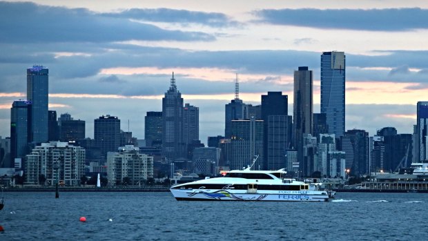 Clouds lower over the CBD as the Port Phillip Ferry heads into dock.