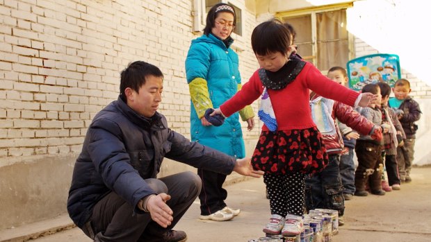 Millions of rural children in China have been "left behind" by parents travelling to cities to work. 