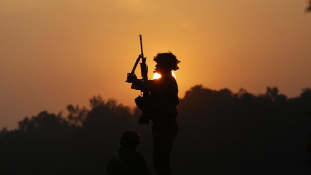 Indian troops were still battling at least two gunmen Sunday evening at the air force base near the country's border with Pakistan.